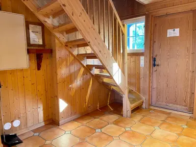 a staircase in a room with wooden walls at Charming Family Cabin With Stunning Mountain Views in Beitostøl