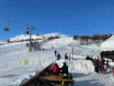 a group of people on a snow covered ski slope at Charming Family Cabin With Stunning Mountain Views in Beitostøl