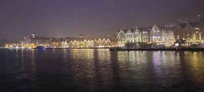 a large body of water with a city at night at Bergen City Center Bryggen in Bergen