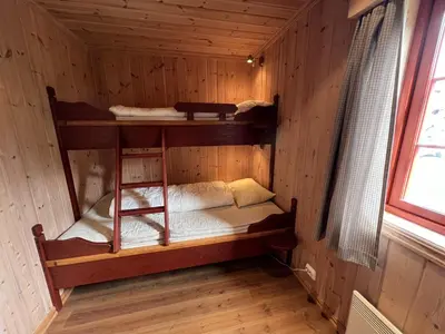 a room with two bunk beds in a cabin at Modern Retreat By Beitostølen Ski Stadium in Beitostøl