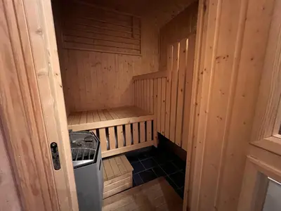 a small sauna with a trash can in it at 3-Story Apartment Near Slopes With Sauna And Views in Beitostøl