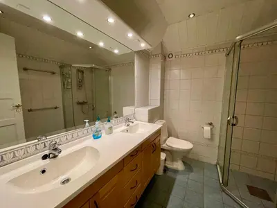 a bathroom with a sink and a toilet and a mirror at 3-Story Apartment Perfect For Up To 10 Guests in Beitostøl