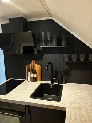 a kitchen with a sink and a counter top at NY og moderne studioleilighet med elbil lading in Gjøvik