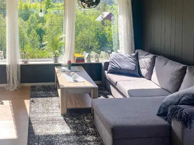 a living room with a couch and a coffee table at 12 person holiday home in Davik in Davik