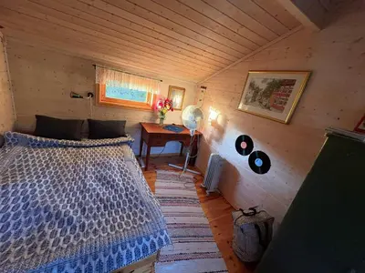 a bedroom with a bed and a table in a room at 8 person holiday home in frosta in Vollen