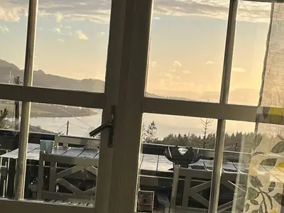 a window with a view of a mountain view at 8 person holiday home in frosta in Vollen