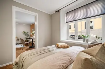 a bedroom with a large bed and a window at Leilighet - midt i sentrum! in Bergen