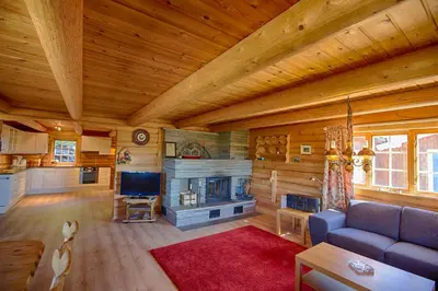 a living room with a couch and a fireplace at Large Cabin Retreat Perfect For Family Gatherings in Beitostøl