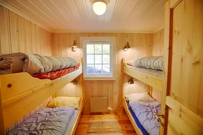 a room with three bunk beds and a window at Large Cabin Retreat Perfect For Family Gatherings in Beitostøl