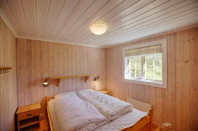 a bedroom with a bed and a window at Large Cabin Retreat Perfect For Family Gatherings in Beitostøl