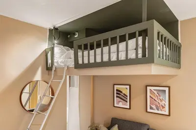 a loft bed in a room with a bunk bed at DINBNB Apartments l Historical Building I 100m To University Museum in Bergen