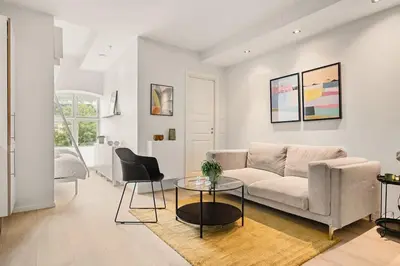 a living room with a couch and a table at DINBNB Apartments l Historical Building I 100m To University Museum in Bergen