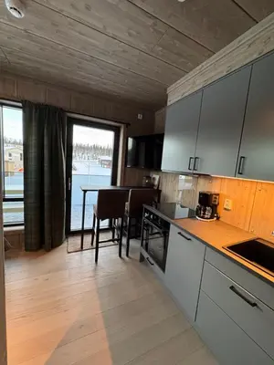 a kitchen with a table and a dining room at Mosetertoppen Skistadion - Hafjell Ski Resort in Hafjell