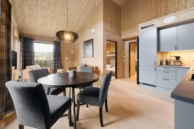 a kitchen and dining room with a table and chairs at Mosetertoppen Skistadion - Hafjell Ski Resort in Hafjell