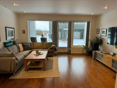 a living room with a couch and a table at Rekkehus til leie under ski-VM in Heimdal