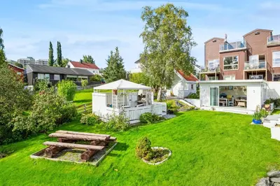 a backyard with a picnic table and a gazebo at Sentral enebolig til utleie under Ski VM 2025 in Trondheim