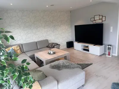 a living room with a couch and a flat screen tv at Enebolig Trondheim syd in Trondheim