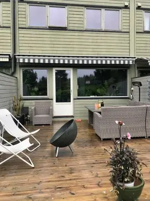 a patio with a white chair and a table and chairs at Rekkehus til leie for ski-VM 2025! I nærheten av VM-arenaen! in Trondheim