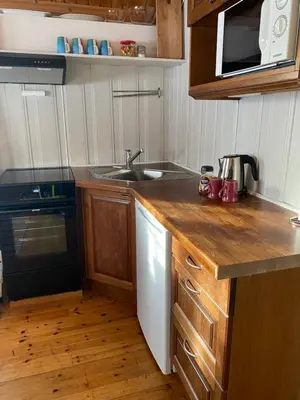 a kitchen with a sink and a counter top at Tørresvangen in Tynset