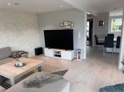 a living room with a large flat screen tv at Stor enebolig Trondheim syd in Trondheim