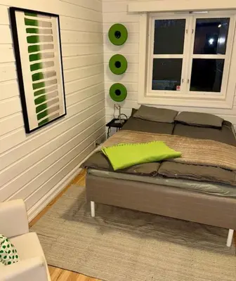 a bed in a room with a window and a bed sidx sidx sidx at Panoramic Fjord View near Bergen in Bergen