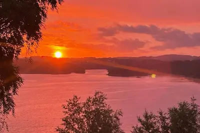 a sunset over a large body of water at Panoramic Fjord View near Bergen in Bergen