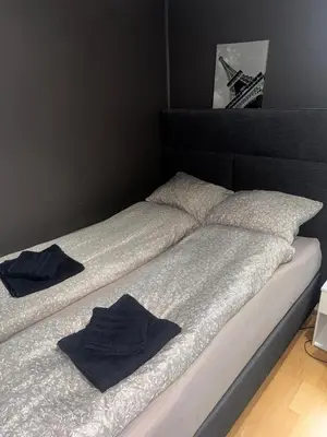 a bed with two blue towels on top of it at Prime location, 400 m from the town centre in Vossevangen