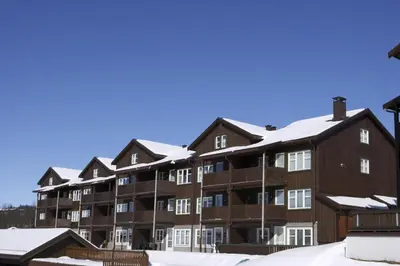 an apartment building with snow on the roof at Spacious Stay With 3 Bedrooms And 2 Baths in Beitostøl