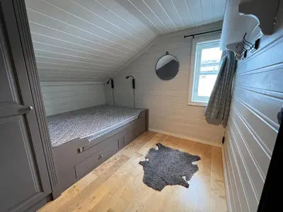 a small room with a bed in a tiny house at Large Balcony With Panoramic Mountain Views in Beitostøl