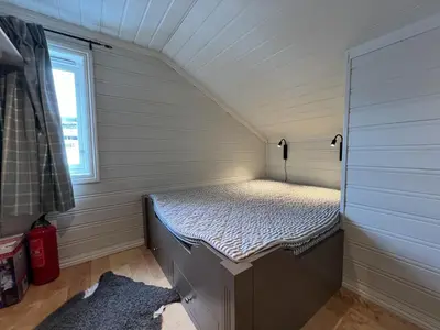 a small room with a bed in the attic at Large Balcony With Panoramic Mountain Views in Beitostøl