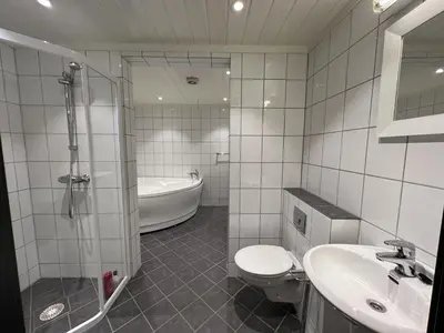 a bathroom with a toilet and a shower and a sink at Large Balcony With Panoramic Mountain Views in Beitostøl