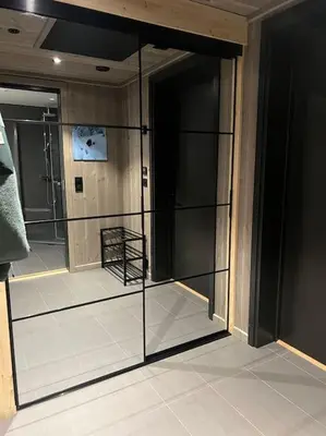 a room with a glass door in a bathroom at Helt ny leilighet ski in- ski out i Hemsedal in Hemsedal