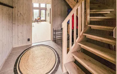 a hallway of a house with stairs and a rug at Stunning Home In Vinje With Wifi in Trovatn