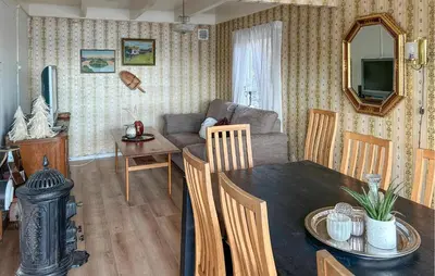 a living room with a couch and a table at Cozy Home In Nerlandsøya Grunnkrets in Kvalsvik