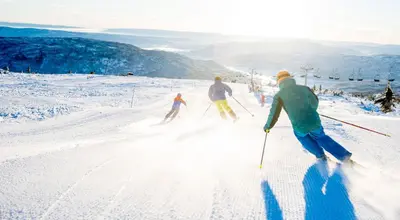 a group of people skiing down a snow covered slope at Koselig hytte sentralt på Norefjell, ski in & out in Surteberg