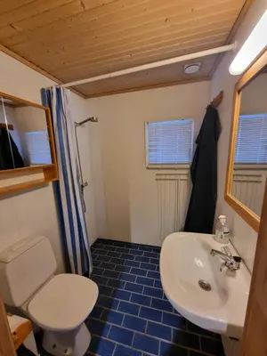 a bathroom with a white sink and a toilet at Koselig hytte sentralt på Norefjell, ski in & out in Surteberg