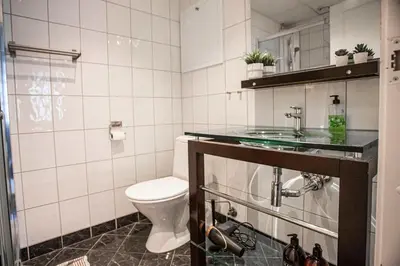 a bathroom with a toilet and a sink at Beautiful Harbour Apartment With French Balcony in Bergen