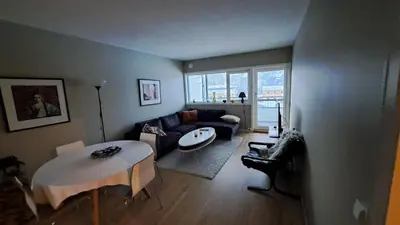 a living room with a table and a couch at Ski in ski out 2bdr apartment in Trondheim
