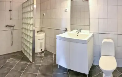 a white bathroom with a sink and a toilet at Gorgeous Apartment With Wifi in Godvik