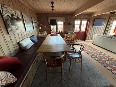 a dining room with a long table and chairs at Spacious cabin with beautiful Geilo views in Geilo