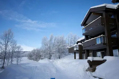 a building covered in snow with a lot of snow at Bright 2-Bedroom With Terrace And Fireplace in Beitostøl