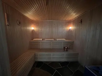 a small sauna with two benches in a room at Grand Log Cabin With Fireplace And 12-14 Beds in Beitostøl