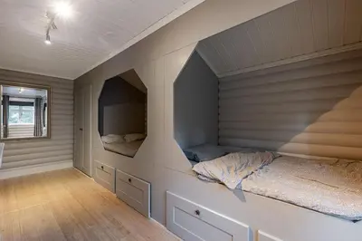 a bedroom with a bed and a tv in it at Hemsedal Mountain Retreat in Hemsedal