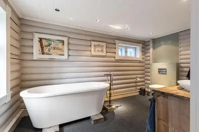 a bathroom with a large white tub and a sink at Hemsedal Mountain Retreat in Hemsedal