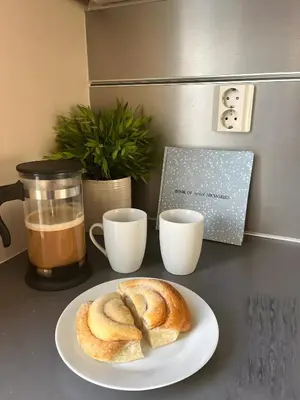 a plate of bread and two cups of coffee on a counter at Lovely 3-room gem in the heart of Bergen City in Bergen