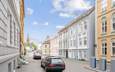 a city street with cars parked on the street at Lovely 3-room gem in the heart of Bergen City in Bergen