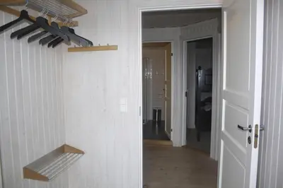 a hallway with a white wall with a knife rack at Apartment By Cross-Country And Alpine Slopes in Beitostøl