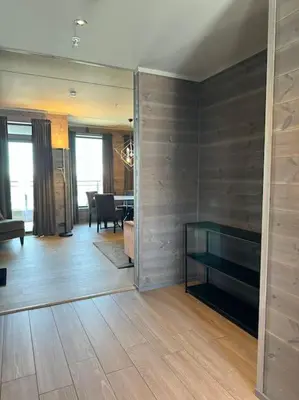 a living room with a table and a dining room at Riddertunets stilfulle in Beitostøl