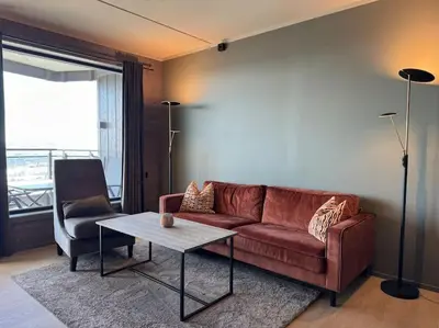 a living room with a brown couch and a table at Riddertunets hygge in Beitostøl