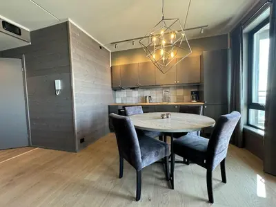 a dining room with a table and chairs in a kitchen at Riddertunets hygge in Beitostøl